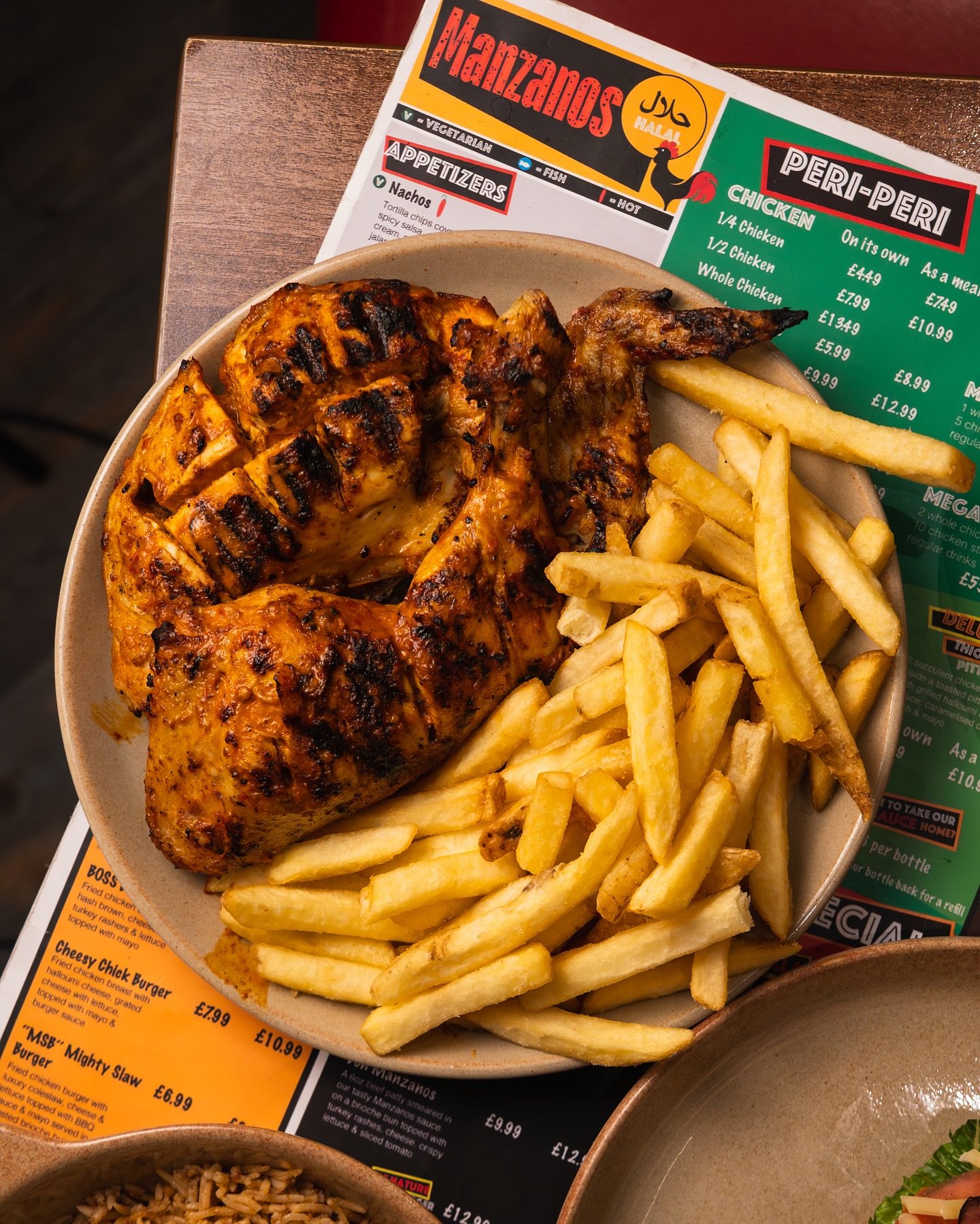 Flame-grilled peri peri chicken platter with chips and the Manzanos menu